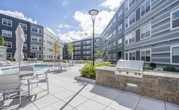 Elevated courtyard with lush landscaping and sunny exposure